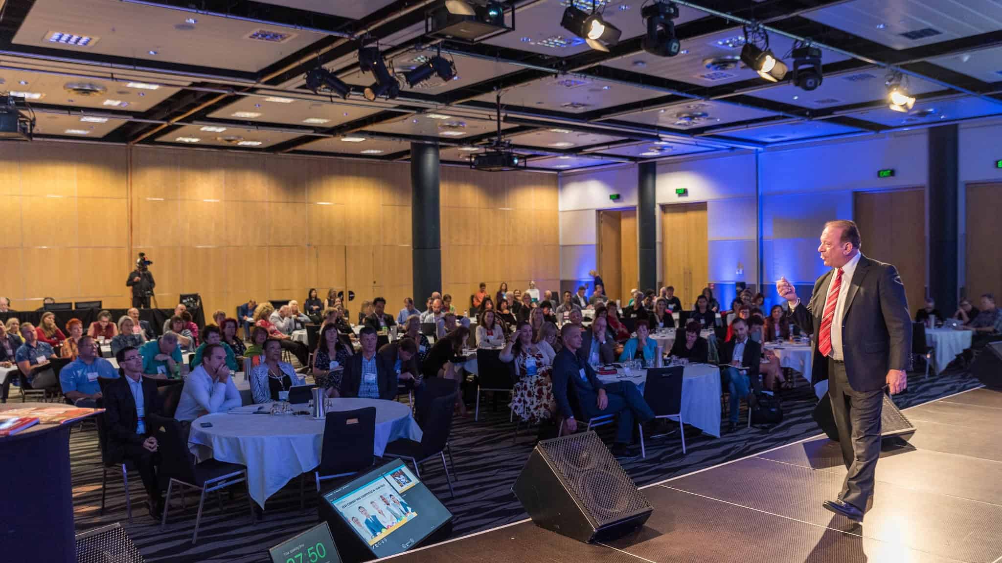 Dr. Rick Goodman transformational leadership speaker presenting on stage to a corporate audience